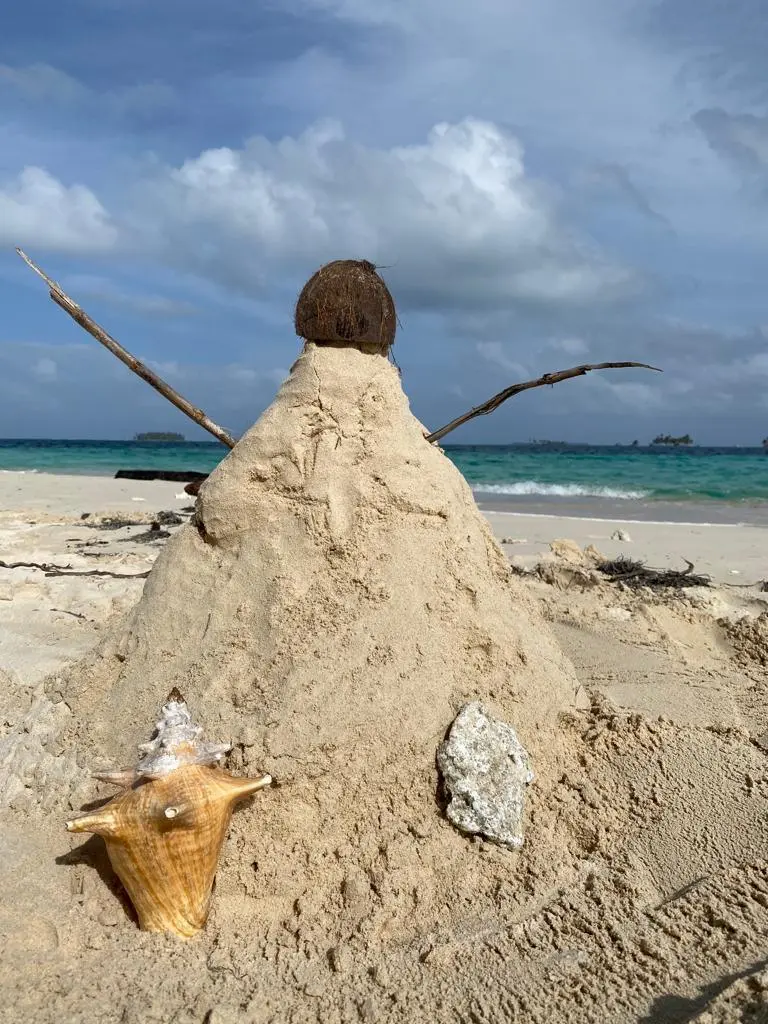 A sand sculpture built on an empty beach